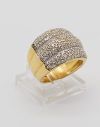 Gold ring with a diamond-pavé top on a clear display stand.