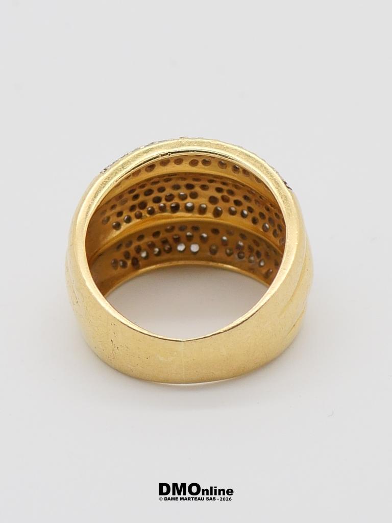 Gold band ring with a perforated or dappled interior, viewed from above on a white background.