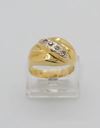 Gold ring with five small diamonds set in a curved band, displayed on a clear stand.