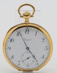 Gold pocket watch with white dial and blue hands, Longines, displayed on a stand