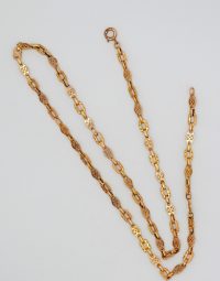 Gold-tone chain necklace with alternating solid and filigree links on a white background.