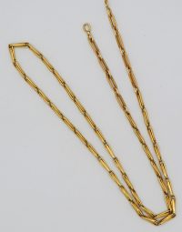 Gold rectangular-link chain necklace laid out on a white surface with a small clasp visible.