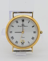 Gold-tone round wristwatch with white dial, Roman numerals, and a date window showing 29.
